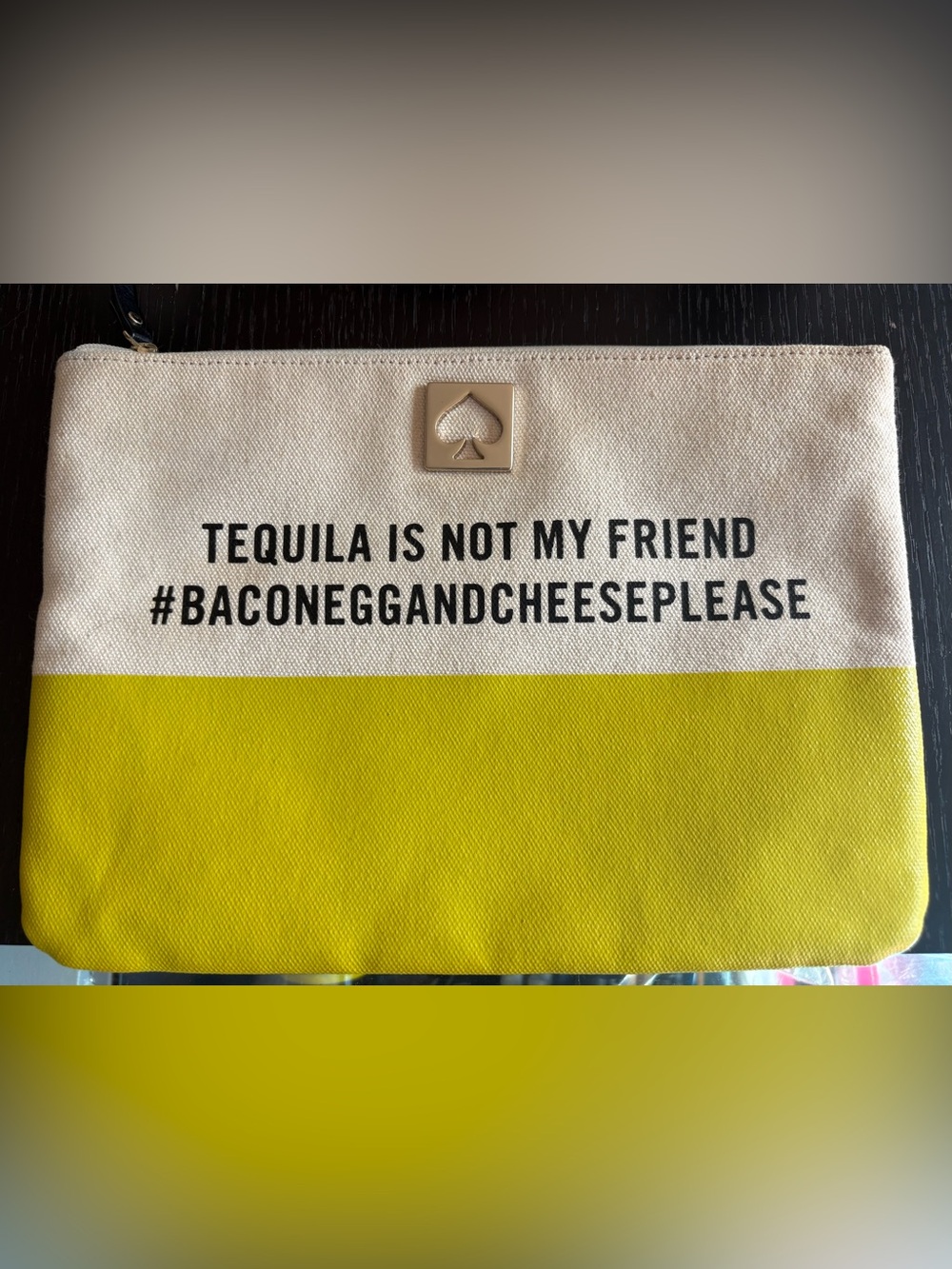 Kate Spade canvas cream and lime pouch with slogan “Tequila is not my friend”